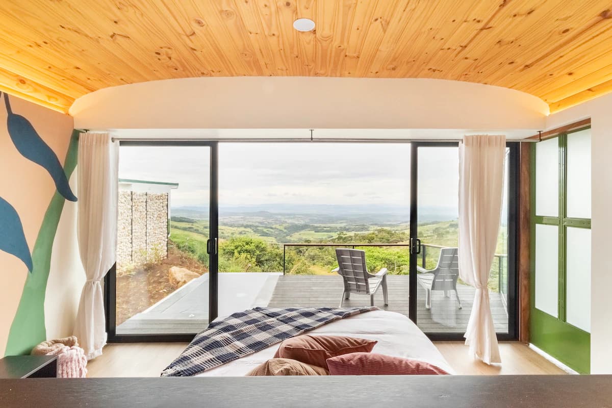 Queen bed facing glass doors and the terrace